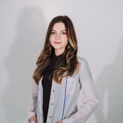 Professional portrait of Olga Zarichna with neutral background